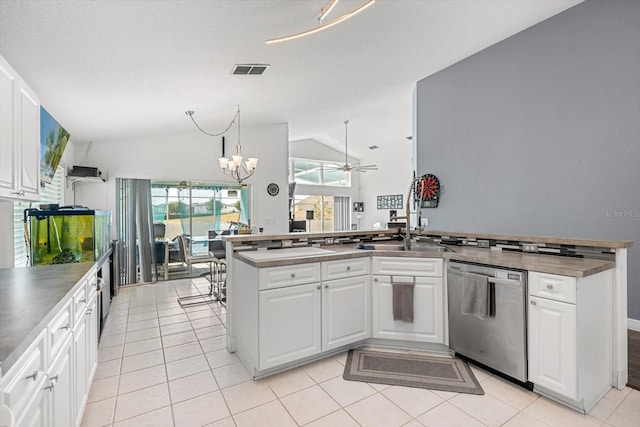 kitchen featuring visible vents, dishwasher, a sink, lofted ceiling, and white cabinetry