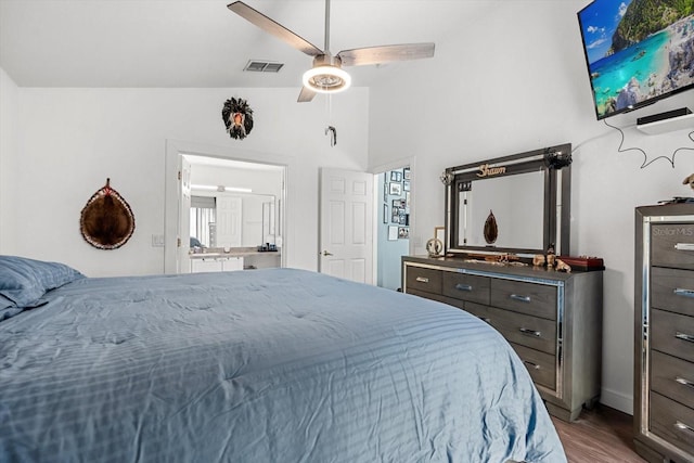 bedroom with visible vents, lofted ceiling, wood finished floors, baseboards, and a ceiling fan