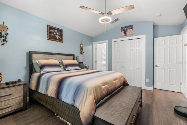 bedroom featuring a ceiling fan, wood finished floors, vaulted ceiling, visible vents, and a closet
