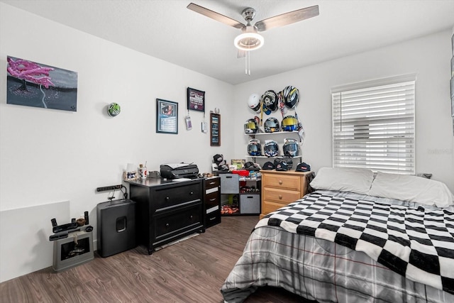 bedroom with ceiling fan and dark wood-style floors