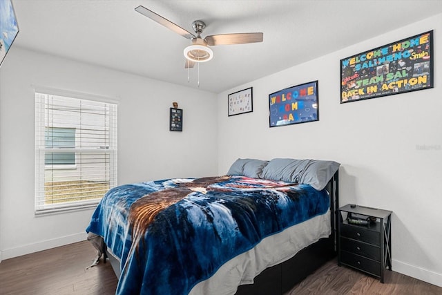 bedroom featuring baseboards, a ceiling fan, and wood finished floors