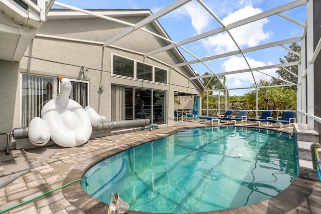 pool with a lanai and a patio area