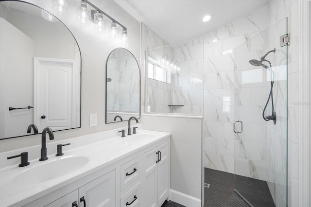 bathroom with double vanity, a sink, and a stall shower