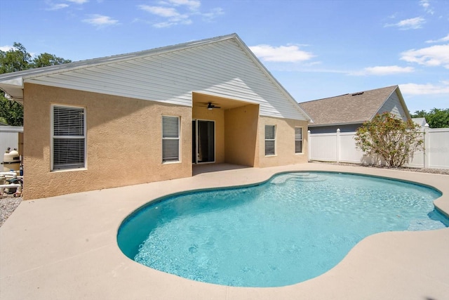outdoor pool featuring a patio and fence