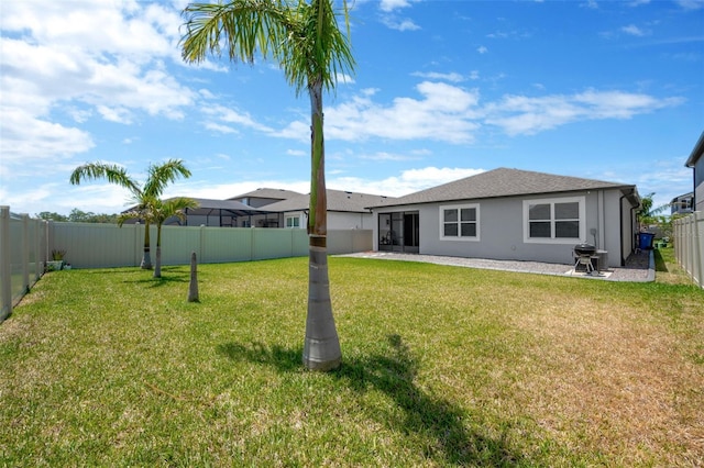 back of house featuring a patio, a fenced backyard, stucco siding, and a yard