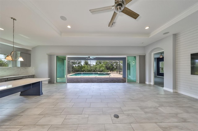 recreation room with a ceiling fan, a tray ceiling, and recessed lighting