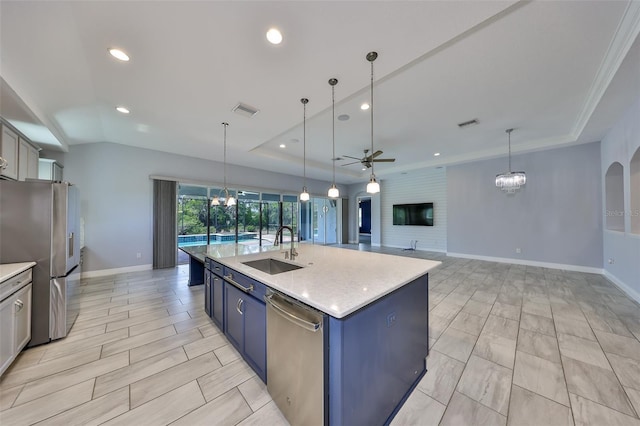 kitchen with visible vents, ceiling fan, a raised ceiling, a sink, and appliances with stainless steel finishes