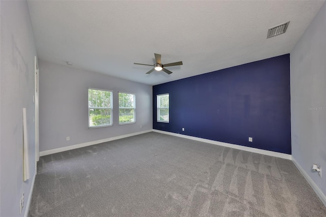 unfurnished room with visible vents, baseboards, ceiling fan, and carpet floors