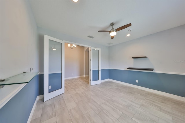 spare room featuring visible vents, baseboards, ceiling fan with notable chandelier, recessed lighting, and light wood-style flooring