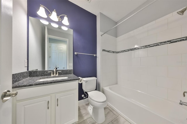 bathroom with vanity, baseboards, toilet, and  shower combination