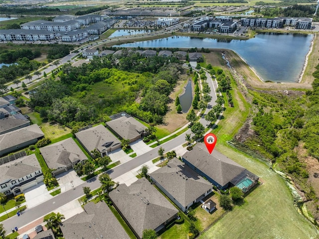 birds eye view of property featuring a water view and a residential view