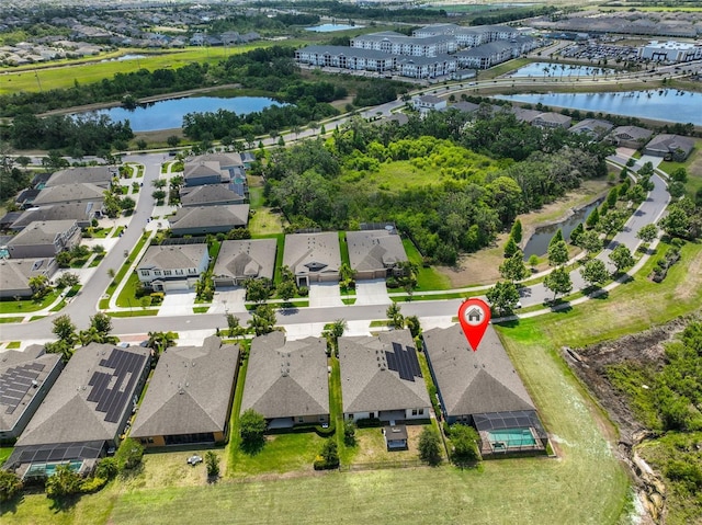 drone / aerial view with a water view and a residential view