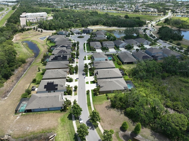 bird's eye view featuring a water view and a residential view