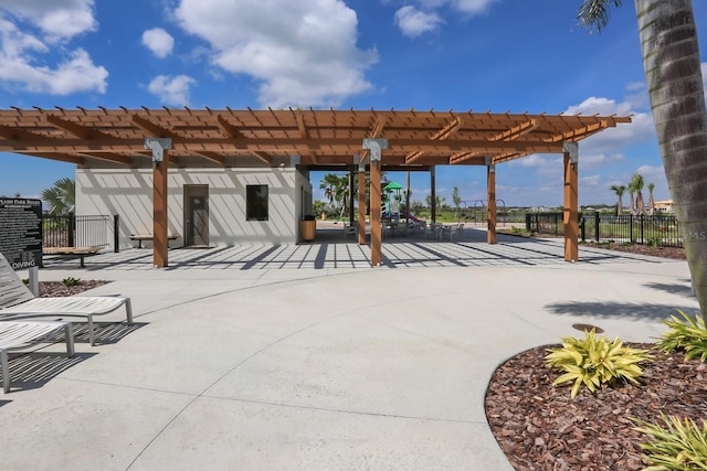view of patio with a pergola and fence