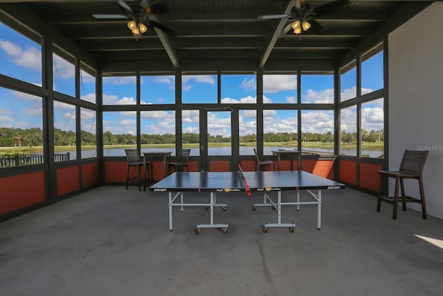 recreation room featuring a ceiling fan and a water view