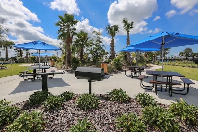 surrounding community featuring a lawn and a patio area