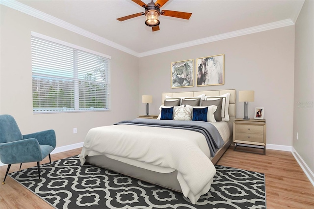 bedroom featuring crown molding, baseboards, wood finished floors, and ceiling fan