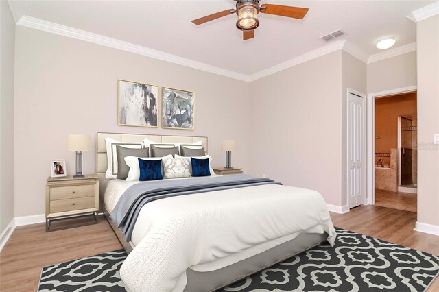 bedroom featuring crown molding, light wood finished floors, baseboards, ensuite bath, and a ceiling fan
