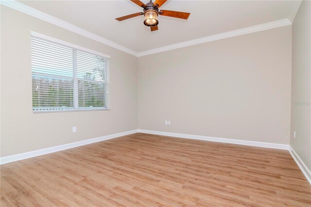 unfurnished room featuring crown molding, light wood-style floors, baseboards, and a ceiling fan