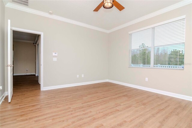 unfurnished room with crown molding, light wood-style flooring, ceiling fan, and baseboards
