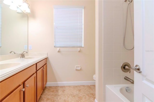 bathroom featuring double vanity, toilet,  shower combination, tile patterned flooring, and baseboards