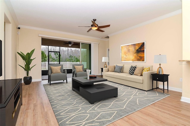 living area featuring crown molding, a ceiling fan, wood finished floors, and baseboards