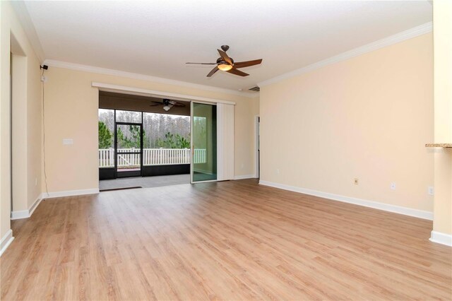 empty room featuring light wood-style floors, ornamental molding, a ceiling fan, and baseboards