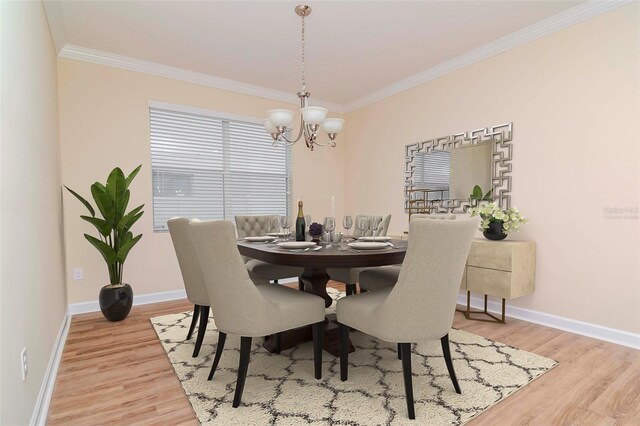 dining space featuring ornamental molding, a chandelier, light wood-type flooring, and baseboards