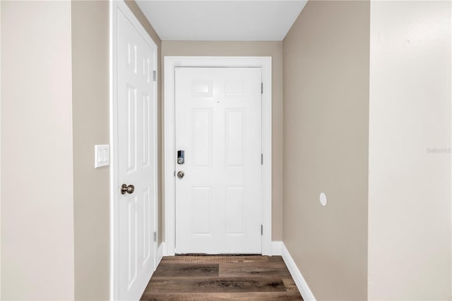 doorway to outside with baseboards and dark wood finished floors
