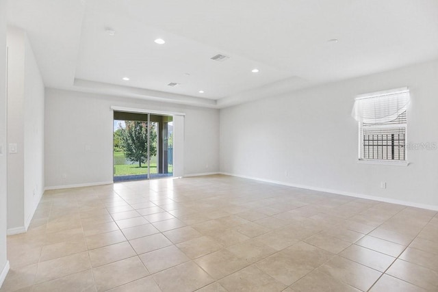 9309 Tradewater Oaks Ct, Riverview, FL 33578 - empty room featuring a raised ceiling, light tile patterned flooring, baseboards, and recessed lighting