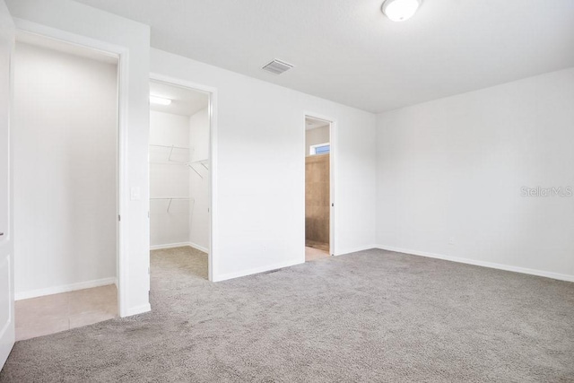 9309 Tradewater Oaks Ct, Riverview, FL 33578 - unfurnished bedroom with carpet floors, a walk in closet, a closet, and baseboards