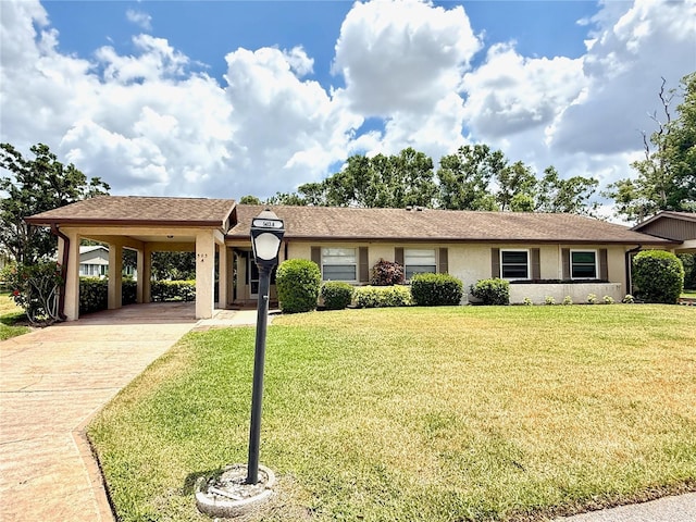 ranch-style house featuring a carport, stucco siding, concrete driveway, and a front lawn