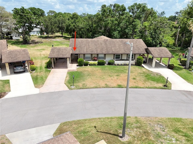 single story home featuring a front yard and concrete driveway