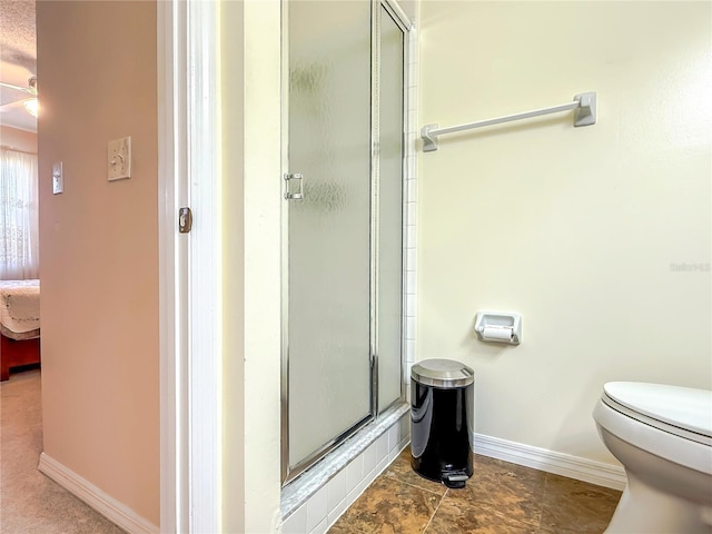 bathroom with baseboards, ensuite bath, a stall shower, and toilet