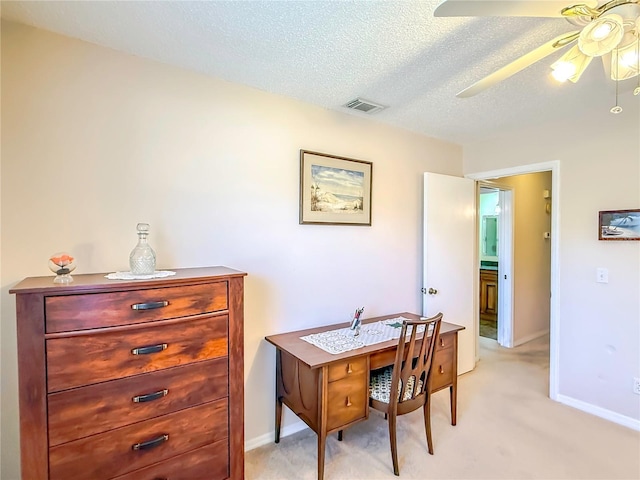 home office with ceiling fan, light colored carpet, a textured ceiling, and visible vents