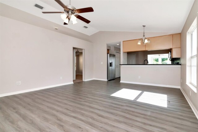 8561 Deer Chase Dr, Riverview, FL 33578 - unfurnished living room with visible vents, dark wood-style flooring, lofted ceiling, and ceiling fan with notable chandelier