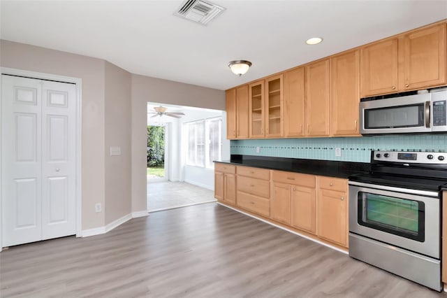 8561 Deer Chase Dr, Riverview, FL 33578 - kitchen featuring light brown cabinetry, baseboards, visible vents, dark countertops, and appliances with stainless steel finishes