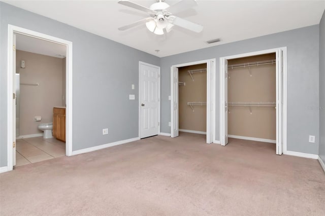 8561 Deer Chase Dr, Riverview, FL 33578 - unfurnished bedroom featuring two closets, ensuite bathroom, carpet floors, and baseboards
