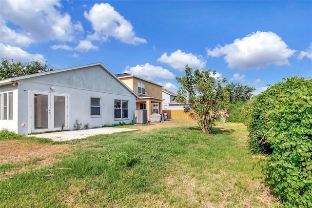 8561 Deer Chase Dr, Riverview, FL 33578 - rear view of property with a yard, fence, a patio, central AC, and stucco siding