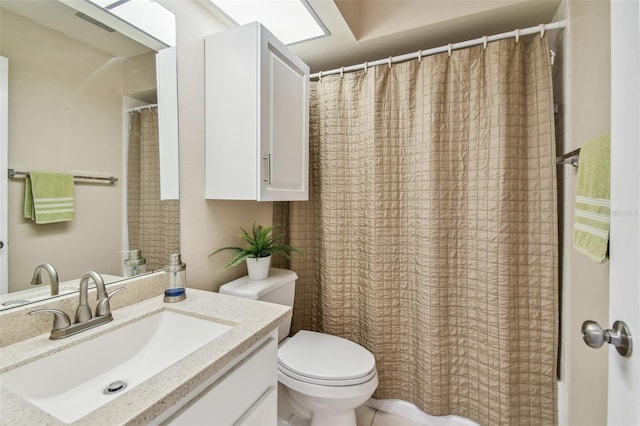 bathroom featuring vanity, a shower with shower curtain, and toilet