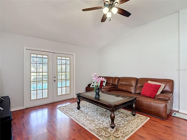 19227 Garden Quilt Cir, Lutz, FL 33558 - living room featuring a ceiling fan, french doors, a textured ceiling, wood finished floors, and lofted ceiling