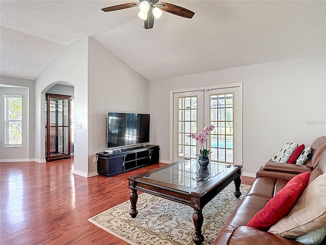 19227 Garden Quilt Cir, Lutz, FL 33558 - living area featuring arched walkways, a textured ceiling, french doors, a ceiling fan, and wood finished floors