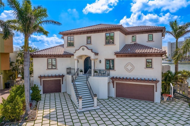 5939 Bayview Cir S, Gulfport, FL 33707 - mediterranean / spanish-style home featuring an attached garage, decorative driveway, and stucco siding