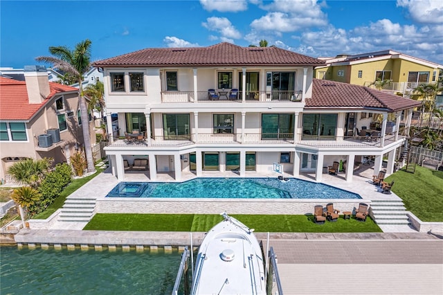 5939 Bayview Cir S, Gulfport, FL 33707 - back of house with a tiled roof, an outdoor pool, a balcony, a patio, and stucco siding