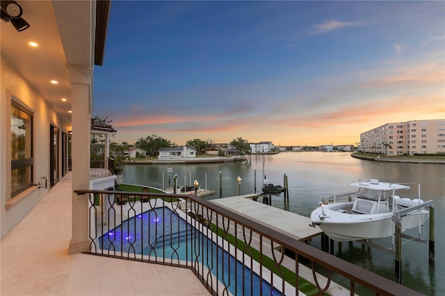 5939 Bayview Cir S, Gulfport, FL 33707 - balcony at dusk featuring a water view, boat lift, and a dock