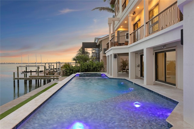 5939 Bayview Cir S, Gulfport, FL 33707 - pool at dusk featuring boat lift, a patio, an outdoor pool, a water view, and an in ground hot tub