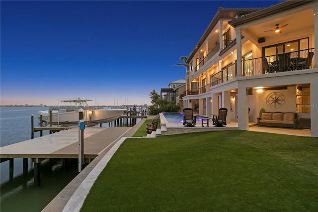 5939 Bayview Cir S, Gulfport, FL 33707 - view of dock with a balcony, boat lift, a patio area, a water view, and a yard