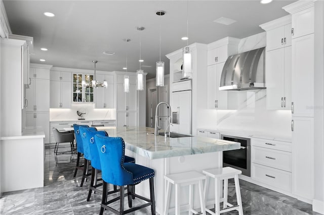 5939 Bayview Cir S, Gulfport, FL 33707 - kitchen featuring recessed lighting, a large island with sink, a sink, and paneled fridge