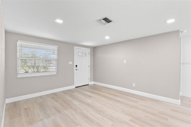 13704 Evelane Dr, Hudson, FL 34667 - entrance foyer with light wood finished floors, baseboards, and recessed lighting