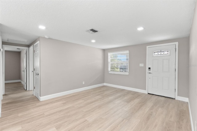 13704 Evelane Dr, Hudson, FL 34667 - entrance foyer with light wood-style flooring, baseboards, and recessed lighting